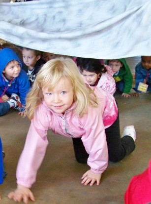 children crawling under blanket - The Very Hungry Caterpillar Gross Motor Activity