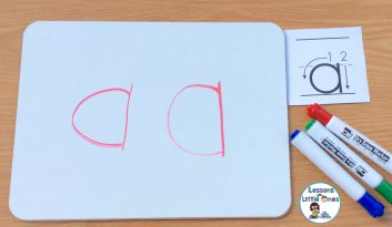 writing alphabet letters on dry erase board